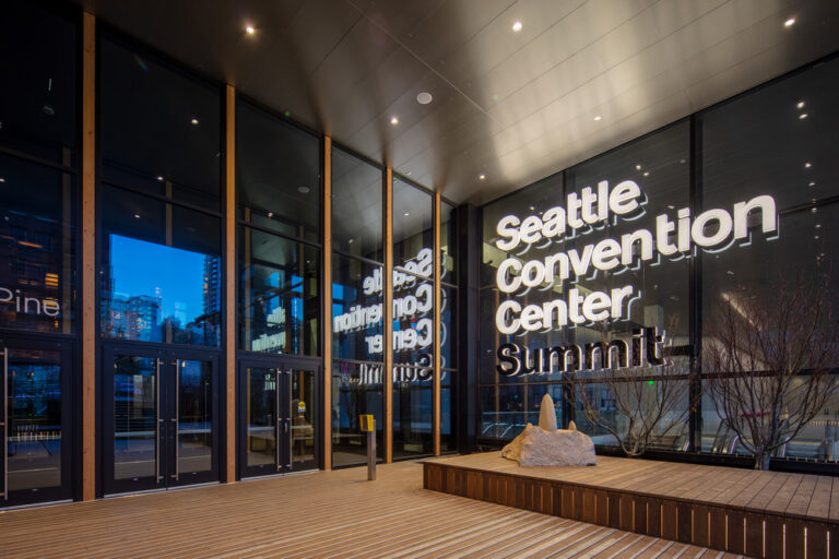 "Seattle Convention Center" in white, illuminated lettering. "Summit" in black, backlit lettering