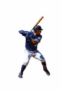 A baseball player in a blue uniform top and great pants holding a bat.