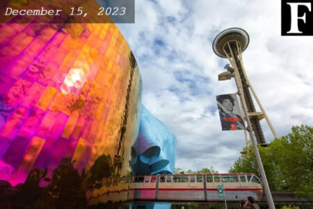 Museum of Pop Culture and Space Needle shown in a clear day. Jimi Hendrix photo displayed on the light pole.
