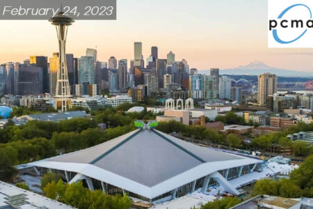 View of Climate Pledge Arena in Seattle. Space Needle displayed in the background on a clear day. Mt. Rainer is displayed in the back as well.