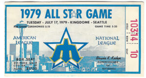 A photo of a ticket for the 1979 MLB All Star Game with graphics of the Space Needle and retro Mariners logo in blue.