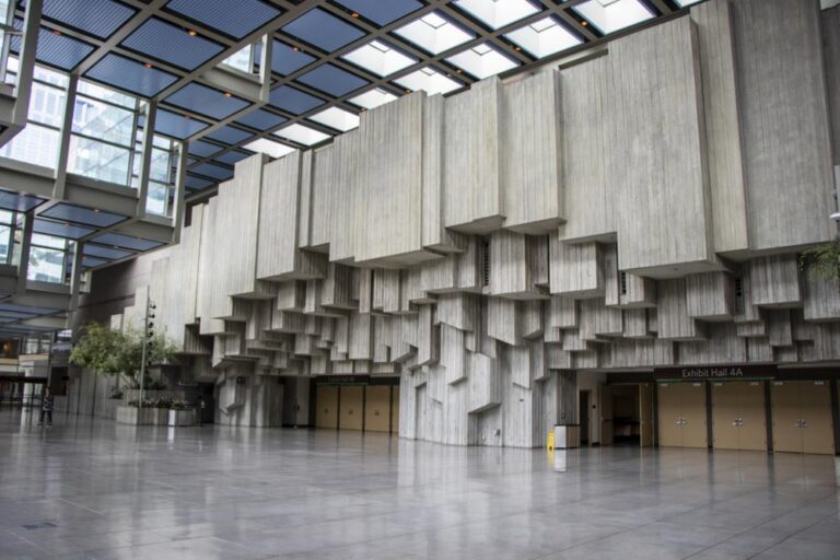 Building lobby with geometric cement wall design above doors